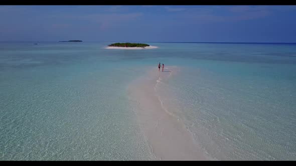 Romantic couple engaged on paradise coastline beach wildlife by blue lagoon with white sand backgrou