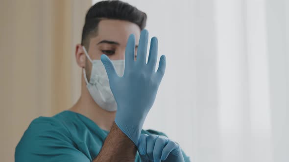 Hospital Arabian Man Worker Surgeon Wearing Hand Gloves Personal Protective Medical Mask in Interior