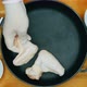 The cook puts the chicken wings in the pan. Chicken wings in a cast iron skillet ready to marinate - VideoHive Item for Sale