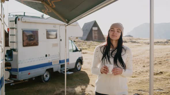 Rv and Beautiful Woman Drink From Cup on Background of Camp in Nature Rbbro