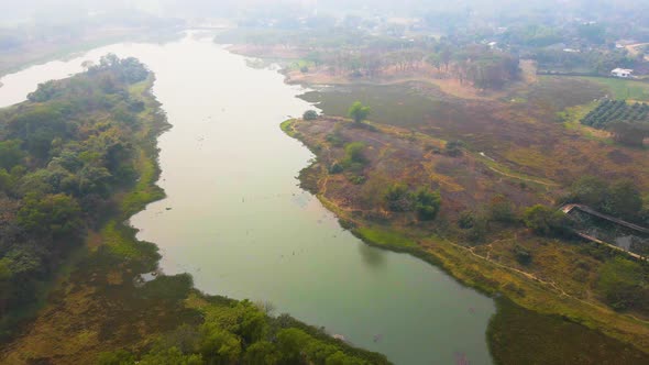 Aerial: river flowing through Bangladesh countryside farming land