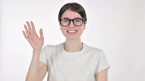 Young Woman Waving Hand at Camera on White Background