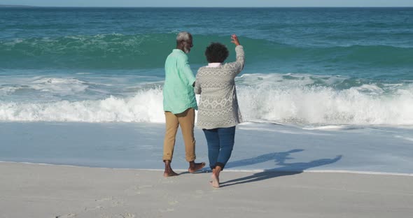 Senior couple walking through the beach