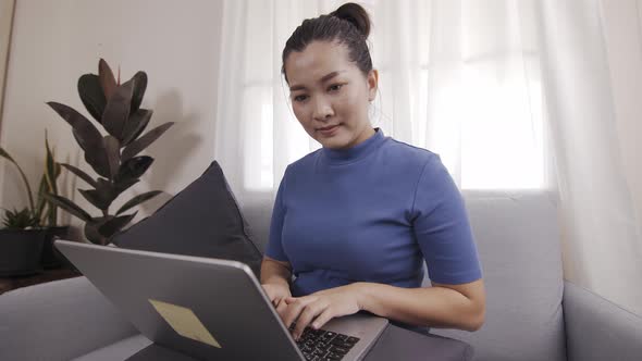 Asian business woman happily use laptops to work from home online