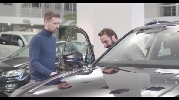 Male Caucasian Car Dealer Opening Car Door, Adult Man Sitting Into Salon