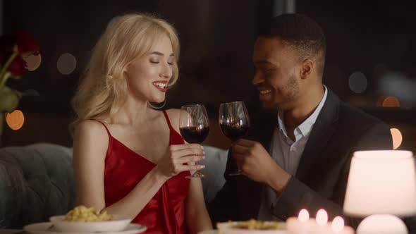 Couple Clinking Glasses Drinking Wine Celebrating Valentine's Day In Restaurant