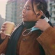 Young woman removing face mask and drinking coffee on street, Italy - VideoHive Item for Sale