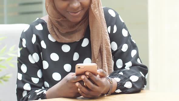 Closeup of the Hands of the Muslim Girls Use a Smartphone