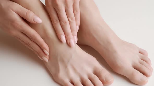 Woman Massaging Her Sprained Foot Closeup