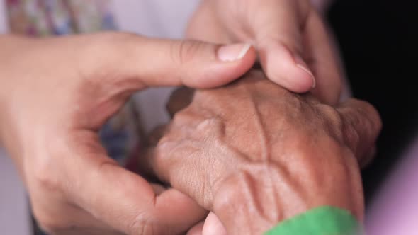 Detail of Women Hand Holding Senior Women's Hand 