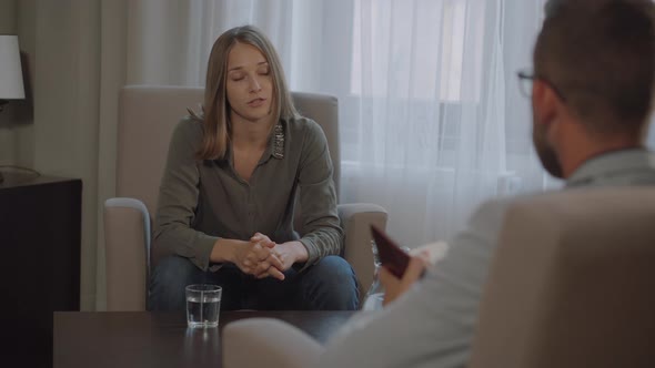 Woman Is Speaking with Man Psychotherapist in Office