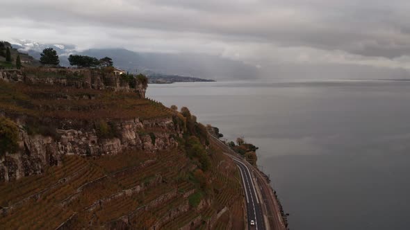 Flying over vineyards in Swiss mountains and revealing the small town Lavaux Vinorama