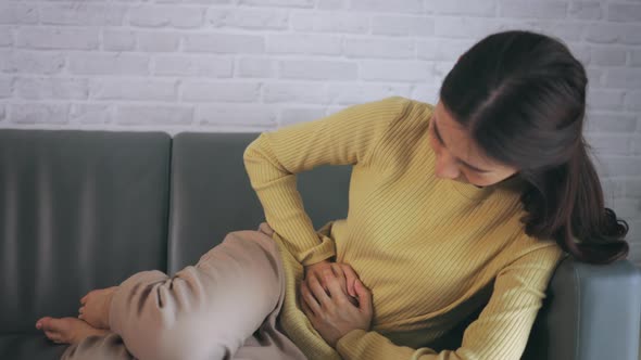 Young Woman Suffering From Stomach Ache