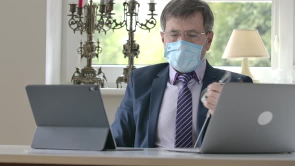 Portrait of Businessman Taking Off Earphones, Face Mask and Eyeglasses and Leaving