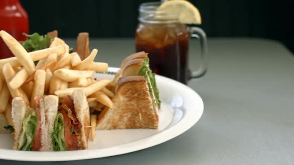 Turkey club sandwich with french fries, and sweet tea