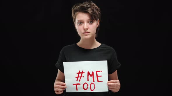 Portrait of Upset Young Woman Posing with Me Too Banner at Black Background