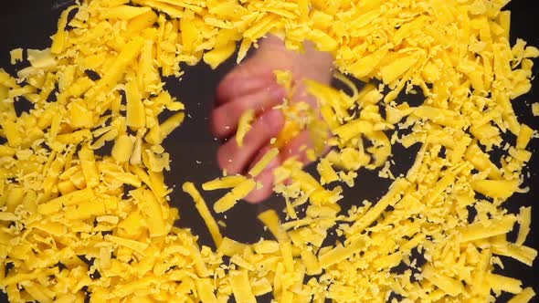 Falling grated cheese on a glass surface