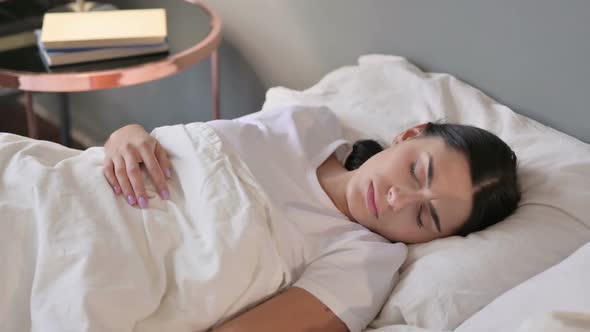 Restless Young Latin Woman Trying Sleeping in Bed