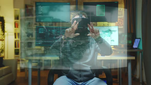 Hacker Wearing VR Headset and Working with AR Holograms