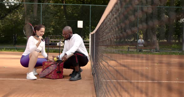 Couple of Tennis Players Having a Conversation at Court