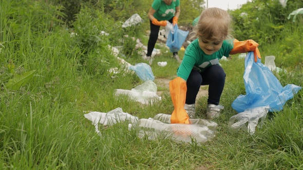 Voluteer Girl Tidying Up Plastic Bags, Bottles Rubbish in Forest. Recycle. Earth Nature Pollution