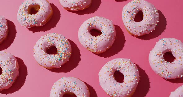 Video of donuts with icing on pink background