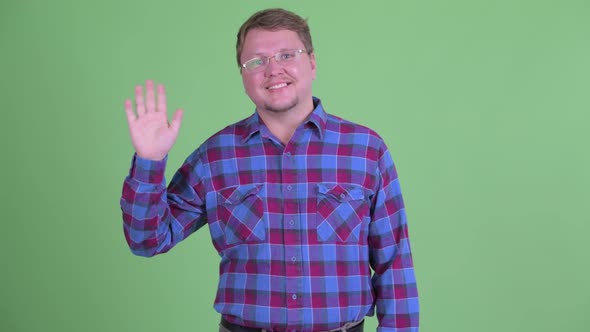 Happy Overweight Bearded Hipster Man Waving Hand