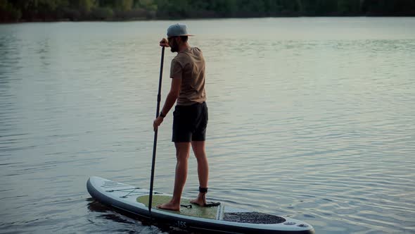 Man Stand Up Paddle Boarding. Warm Summer Beach Vacation Holiday. Travel Paddles Paddleboard.