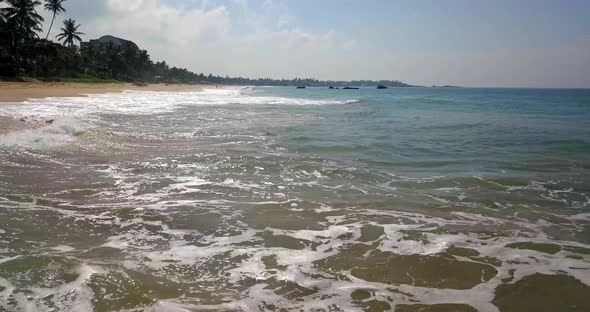 Tropical Landscape of Sand Beach and Sea Waves Rolling in