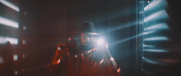 Man flashing flashlight towards camera in lights of shutters