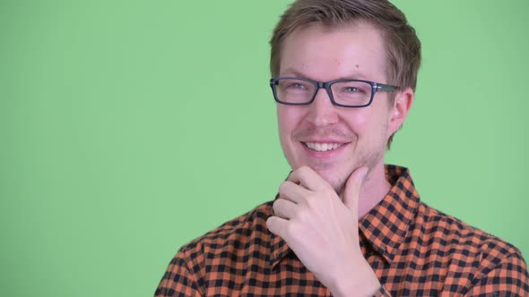 Face of Happy Young Hipster Man Thinking and Looking Up