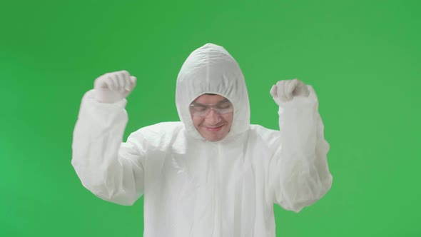 Asian Male Wearing Personal Protective Equipment Uniform Ppe And Dancing In Green Screen Studio