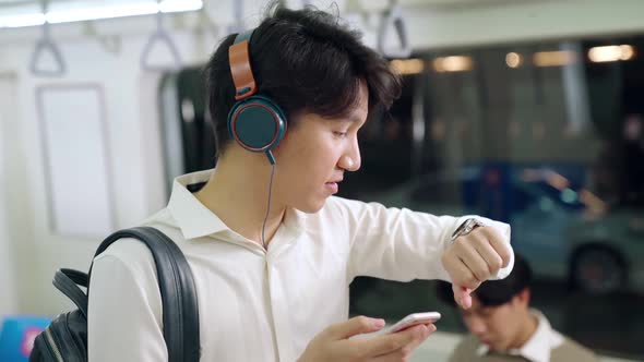 Businessman Using Mobile Phone on Public Train