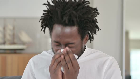 Portrait of Sick African Man Sneezing 