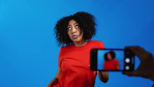 Smiling Vlogger African Woman Recording Video of Herself Dancing in Front of Smartphone Camera on