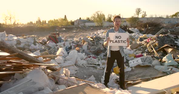 Young Man Activist Holding Poster with Inscription Against Pollution