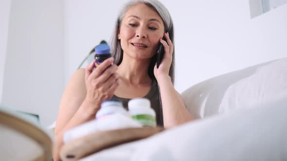 Asian woman talking with her doctor about medications