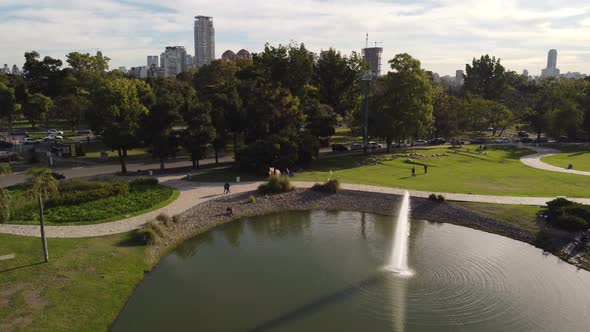 Fountain on lake in Tres de Febrero park with skyscrapers in background, Buenos Aires city. Argentin