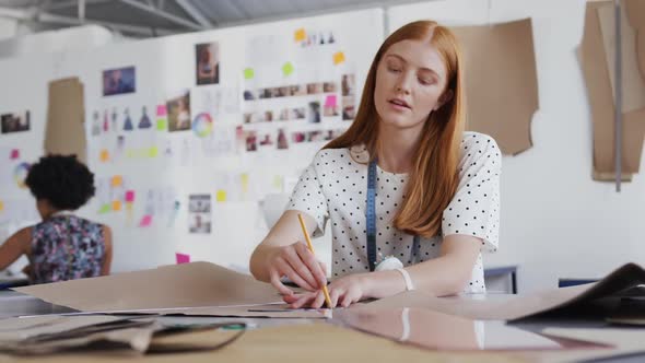 Caucasian woman working in fashion office