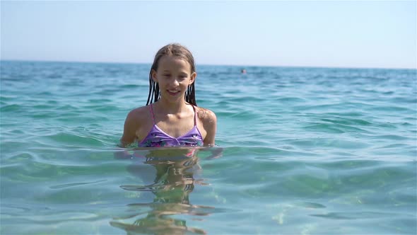 Cute Little Girl at Beach During Summer Vacation