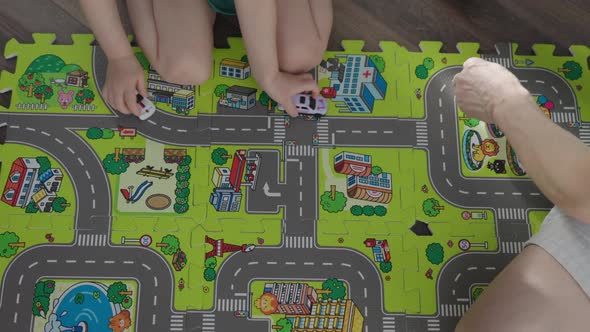 Father Playing Toy Cars with Little Son Child Kid on Floor Road Mat Happy Family