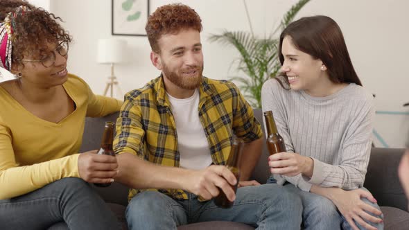 United Multiracial Hipster Student Friends Cheering with Beers at Home