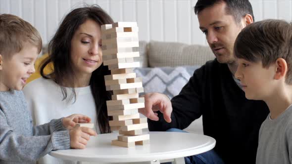 Family Is Playing in Wooden Tower at Home