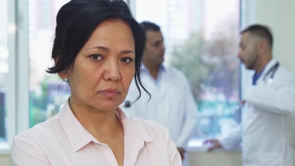 A Sad Patient Is Standing Next To the Doctors in the Office