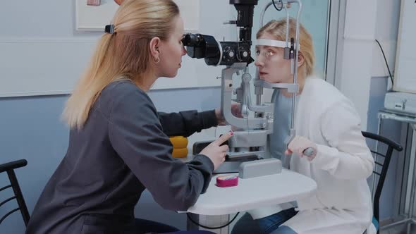 Ophthalmologist Examining the Eyesight of Woman with a Slit Lamp