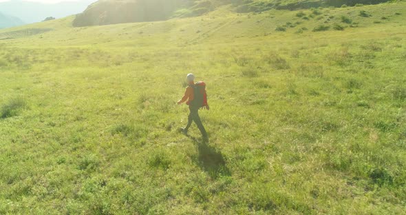 Flight Over Backpack Hiking Tourist Walking Across Green Mountain Field