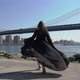 Young Woman in Black Long Dress Walks Near Manhattan Bridge in New York USA - VideoHive Item for Sale