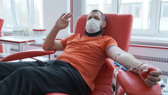 Blood Donor Makes Okay Gesture. Mature Man with Beard Showing Ok Sign and Looking at the Camera