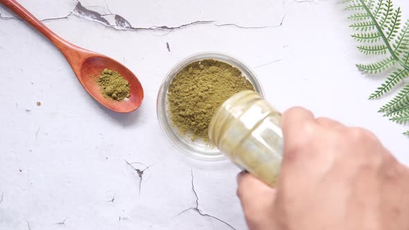 The Wooden Bowl with Rehydrated Henna on Table