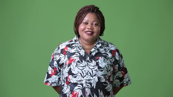 Overweight Beautiful African Woman Against Green Background